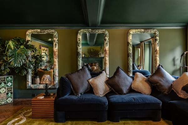 Sumptuous dark velvet lounge sofa framed by heavy gilded wall mirrors, a luxury editorial backdrop in Liss Hampshire GU33 by Love Locations.