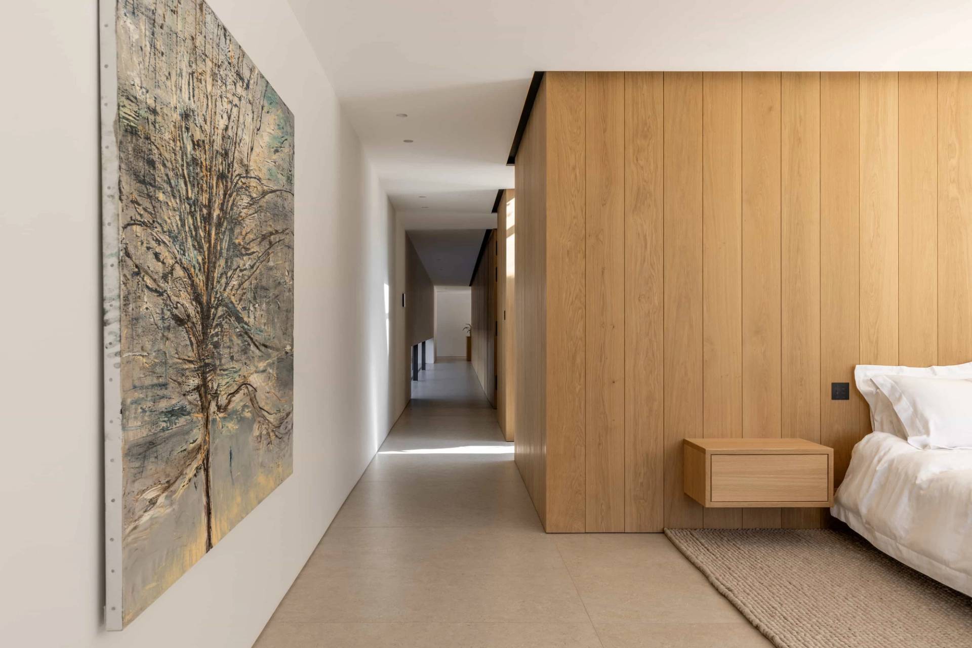Minimalist interior hallway corridor featuring seamless wood panelling, concealed doors, and neutral floor finishes in Fryerning, Love Locations.