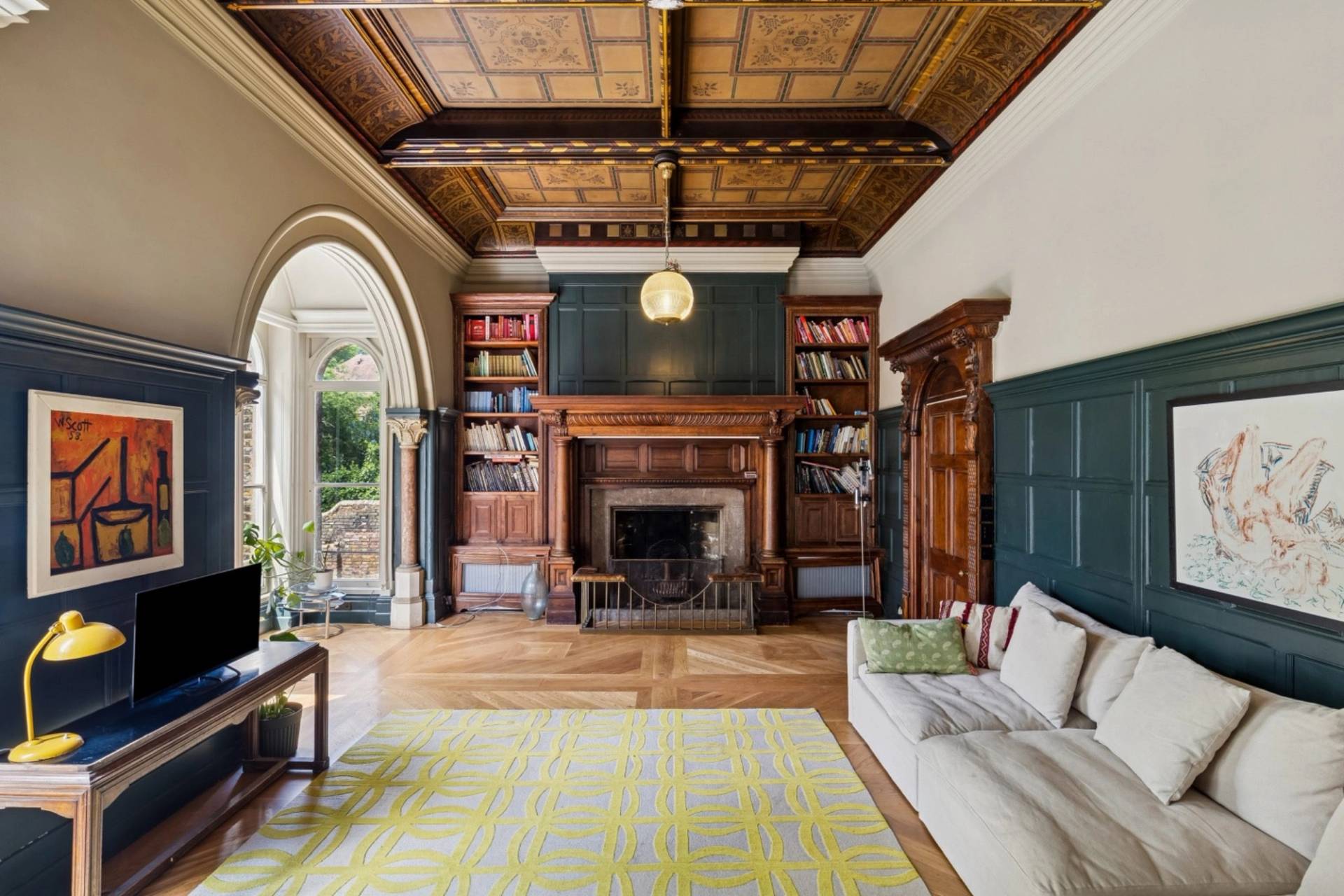 Historic library and living room film location in Hampstead London NW3 by Love Locations, featuring a carved wooden fireplace mantel and coffered ceiling.