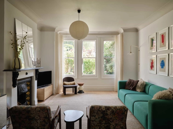 Love Locations characterful family home SE23: Deep perspective look through a light-filled lounge featuring armchair seating and a large bay window, tailored for cinema and television sets.