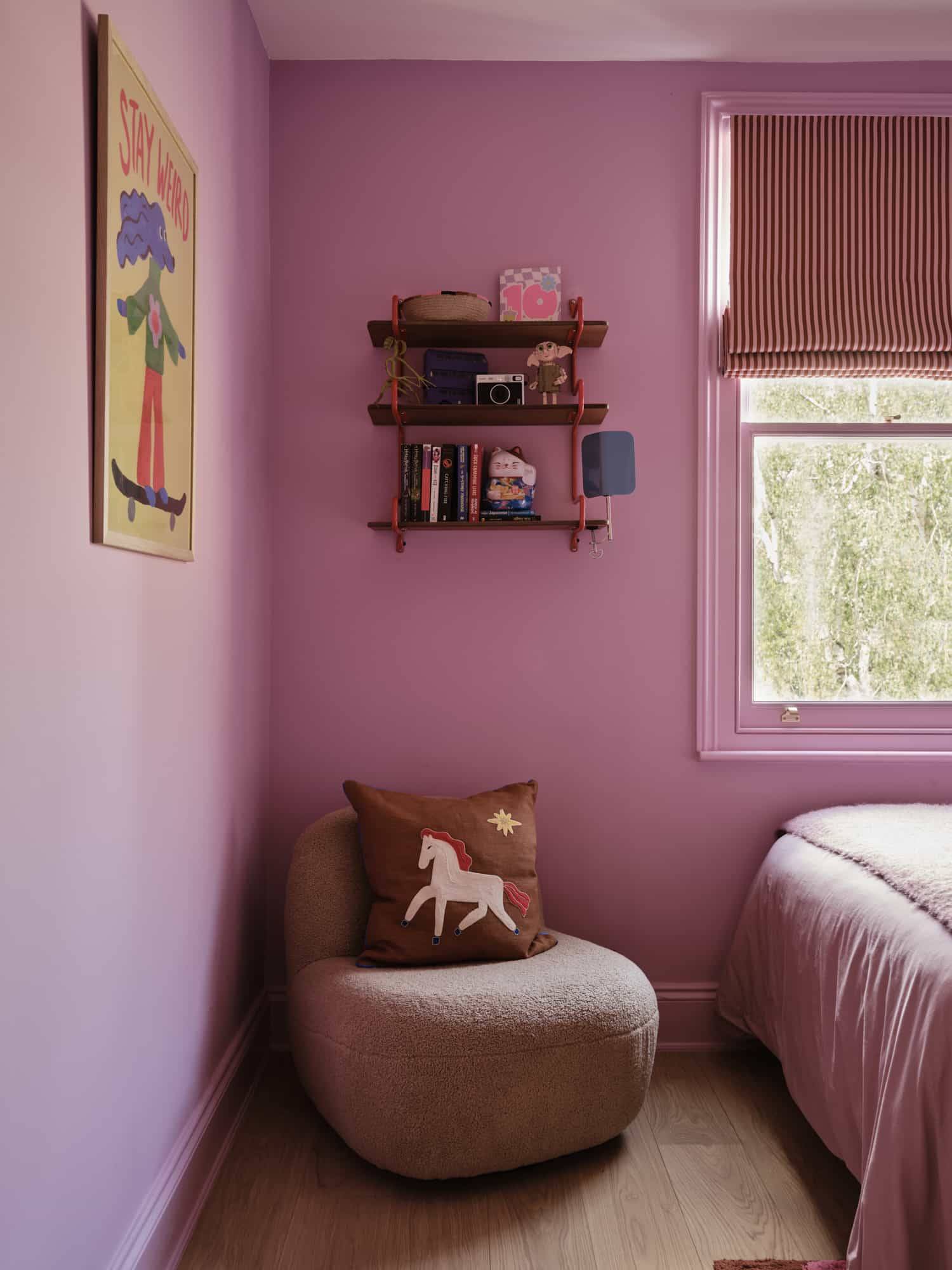 Love Locations colorful residential backdrop Lewisham: Soft pinkish-lilac playroom alcove featuring a plush bouclé beanbag chair, optimized for family lifestyle media.