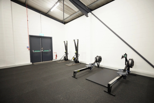 Indoor rowing machines set up on a dedicated track floor for cardio and endurance training, ideal for sports brand shoots, Love Locations SO23.