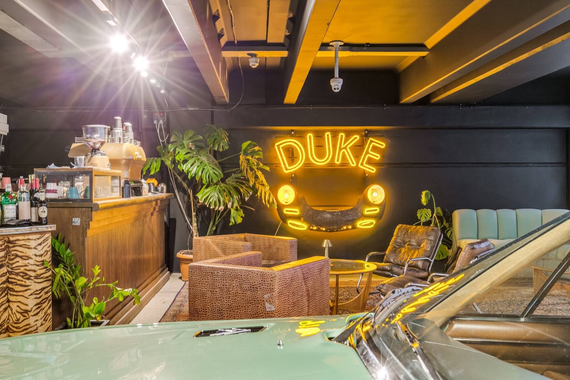 Retro lounge and coffee bar setup in a 1950s industrial car showroom in Brentford TW8 by Love Locations.