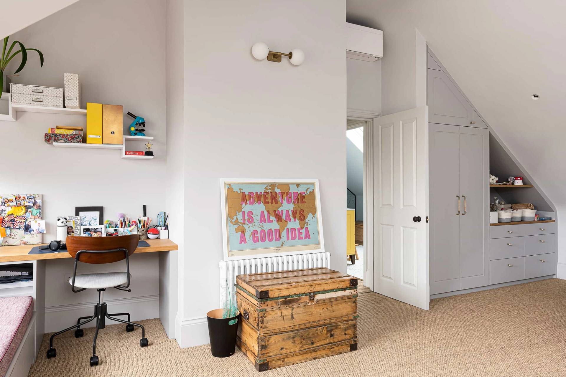 Bright guest bedroom or study featuring a vintage wooden desk, wooden chest, and neutral walls, Love Locations NW6.