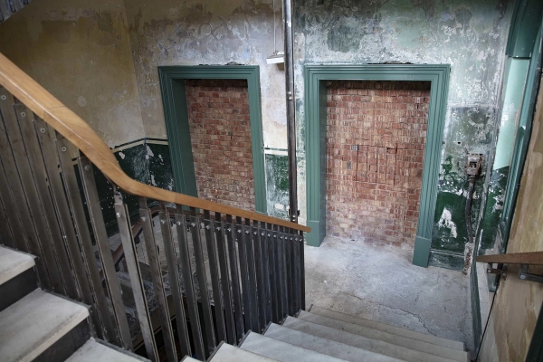 Historic wooden staircase with peeling paint in the Old Waiting Room at Peckham Rye station—perfect South East London location for heritage photoshoots, creative events, and gallery hire.