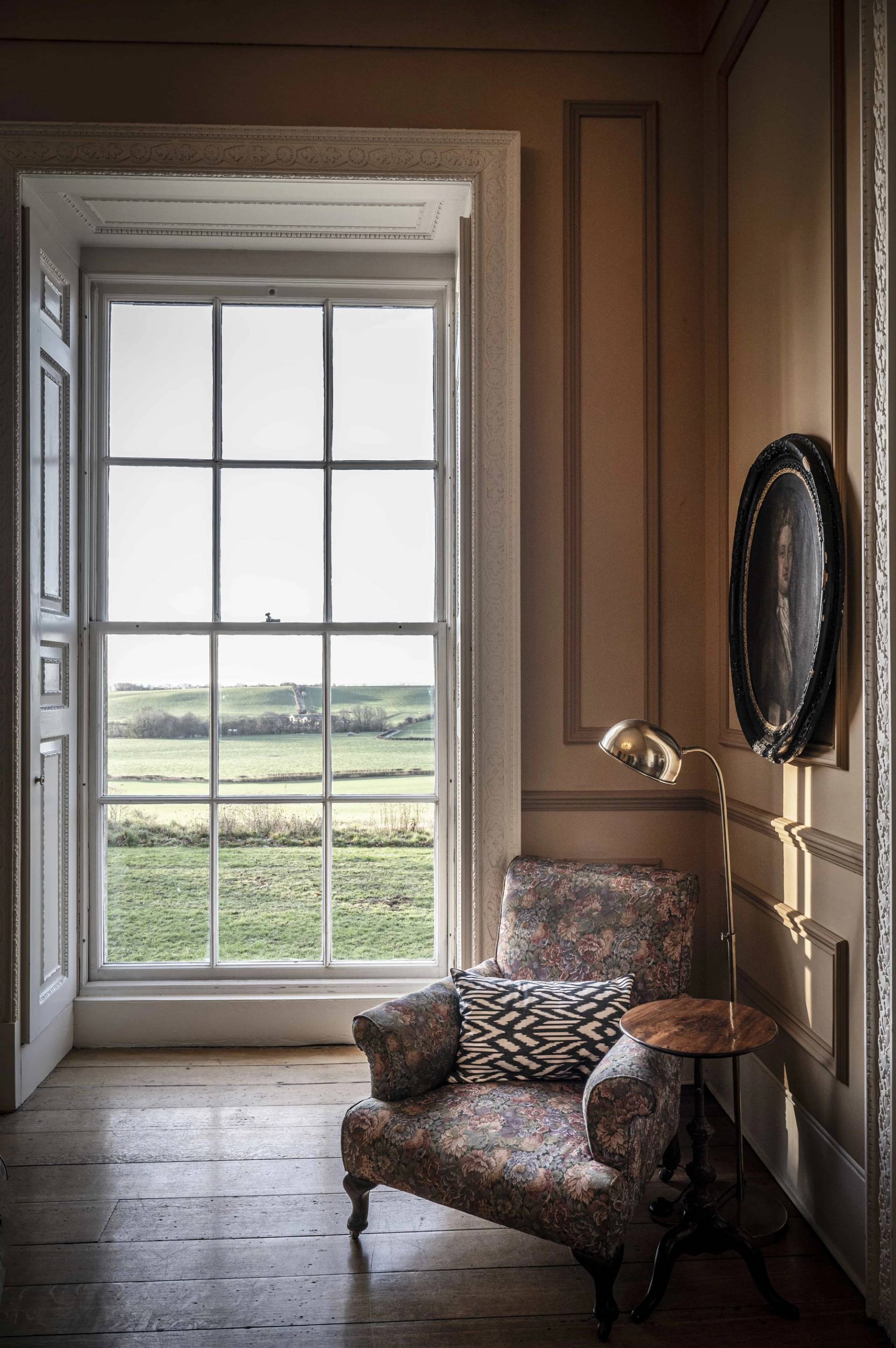 Sash window reading nook with views across the Leicestershire countryside and a vintage armchair, perfect for quiet storytelling scenes, Love Locations LE7.