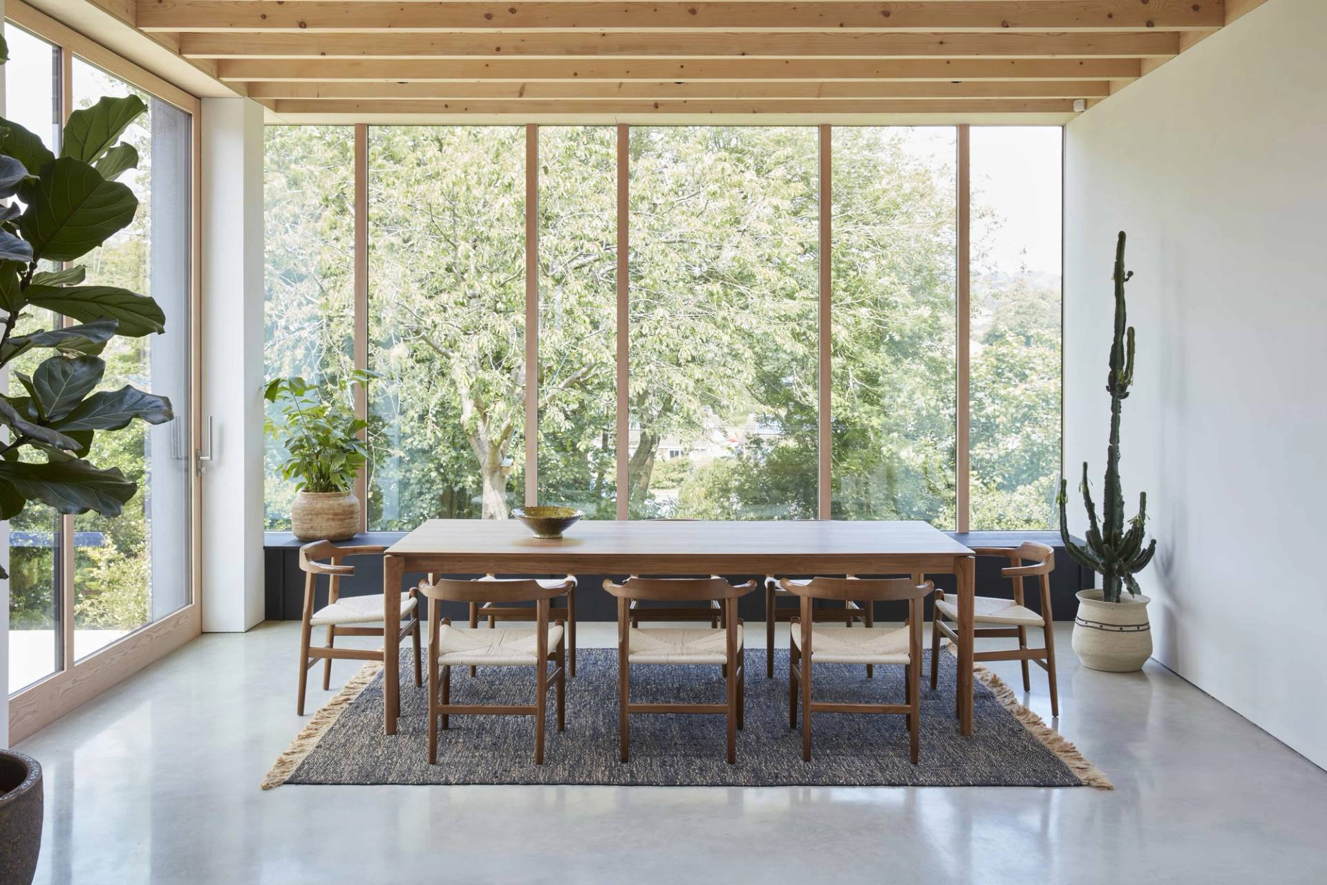 Modern Scandi-style dining room extension with floor-to-ceiling glass timber window walls and exposed roof beams, ideal for lifestyle commercial shoots, Love Locations TN34.
