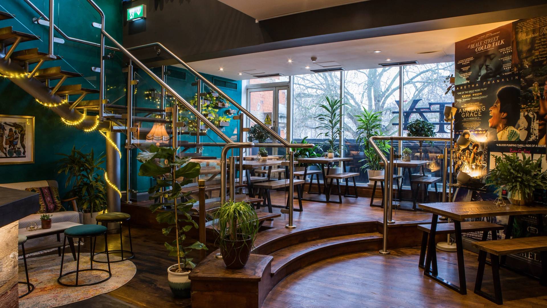 Sunlit cafe-bar seating area near expansive glass windows at The Ritzy, Brixton, SW2, suitable for casual lifestyle brand campaigns and commercial filming, Love Locations.