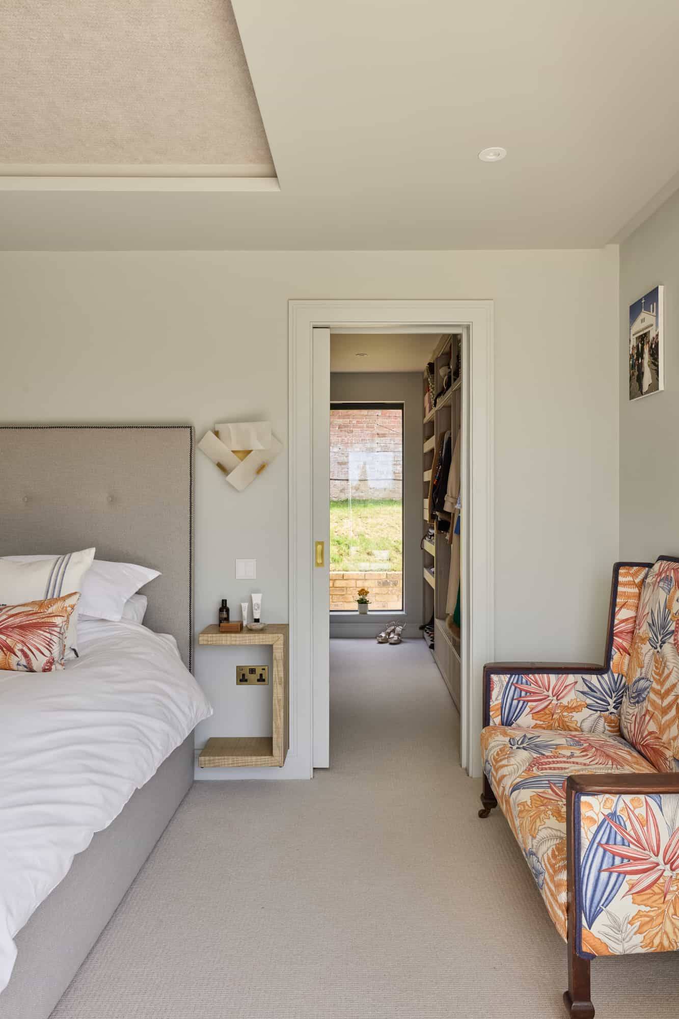 Master bedroom doorway transition looking into a bespoke walk-in dressing room, Love Locations KT22.