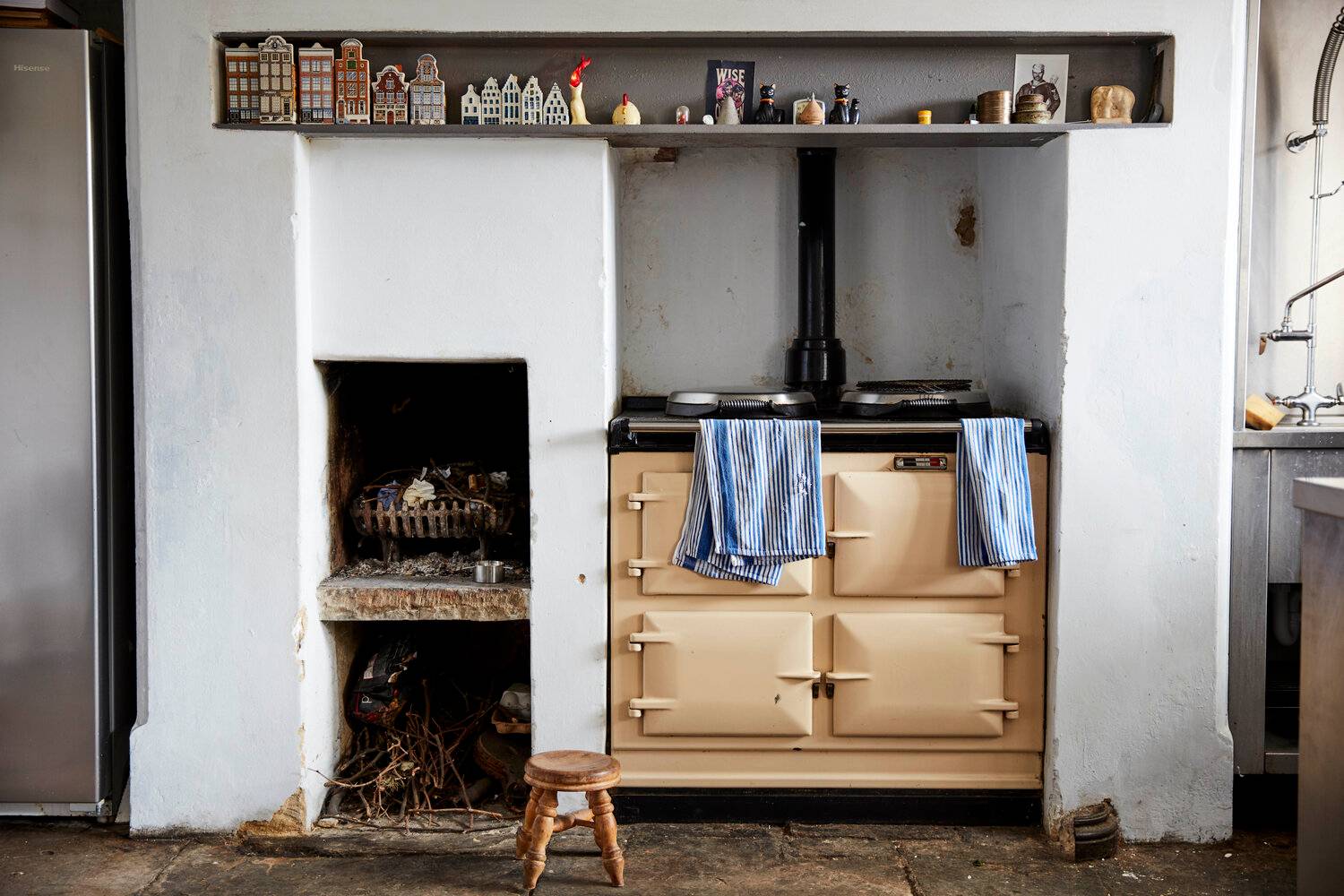 Classic beige AGA range cooker set in a rustic plaster chimney breast with flagstone flooring, perfect for food media filming, Love Locations.