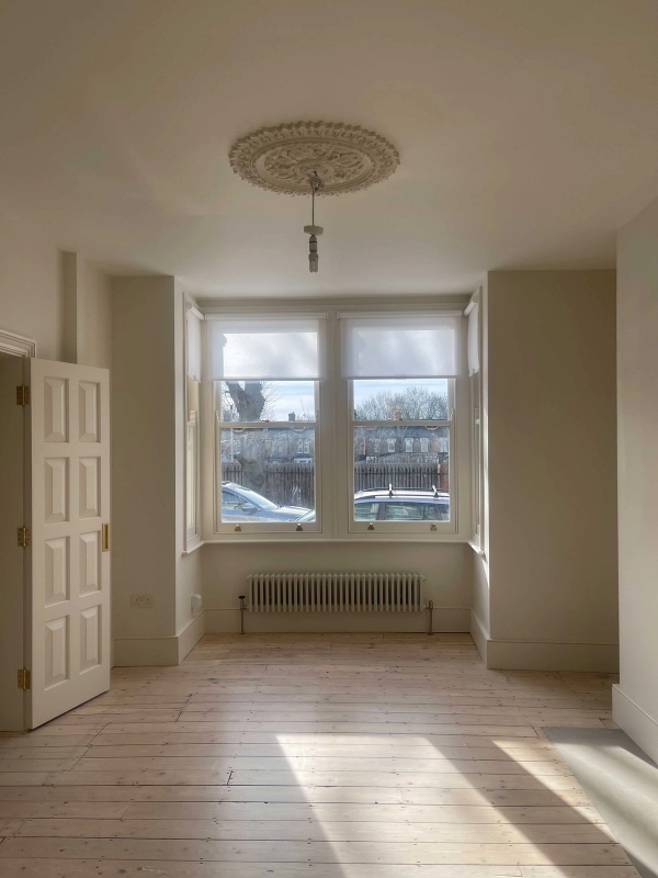 East London home interior with timber floors and large windows