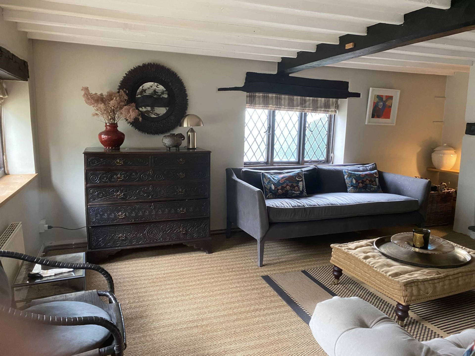 Cozy character sitting room featuring a rustic antique chest of drawers, a small sofa, and a traditional window view, Love Locations RG9.