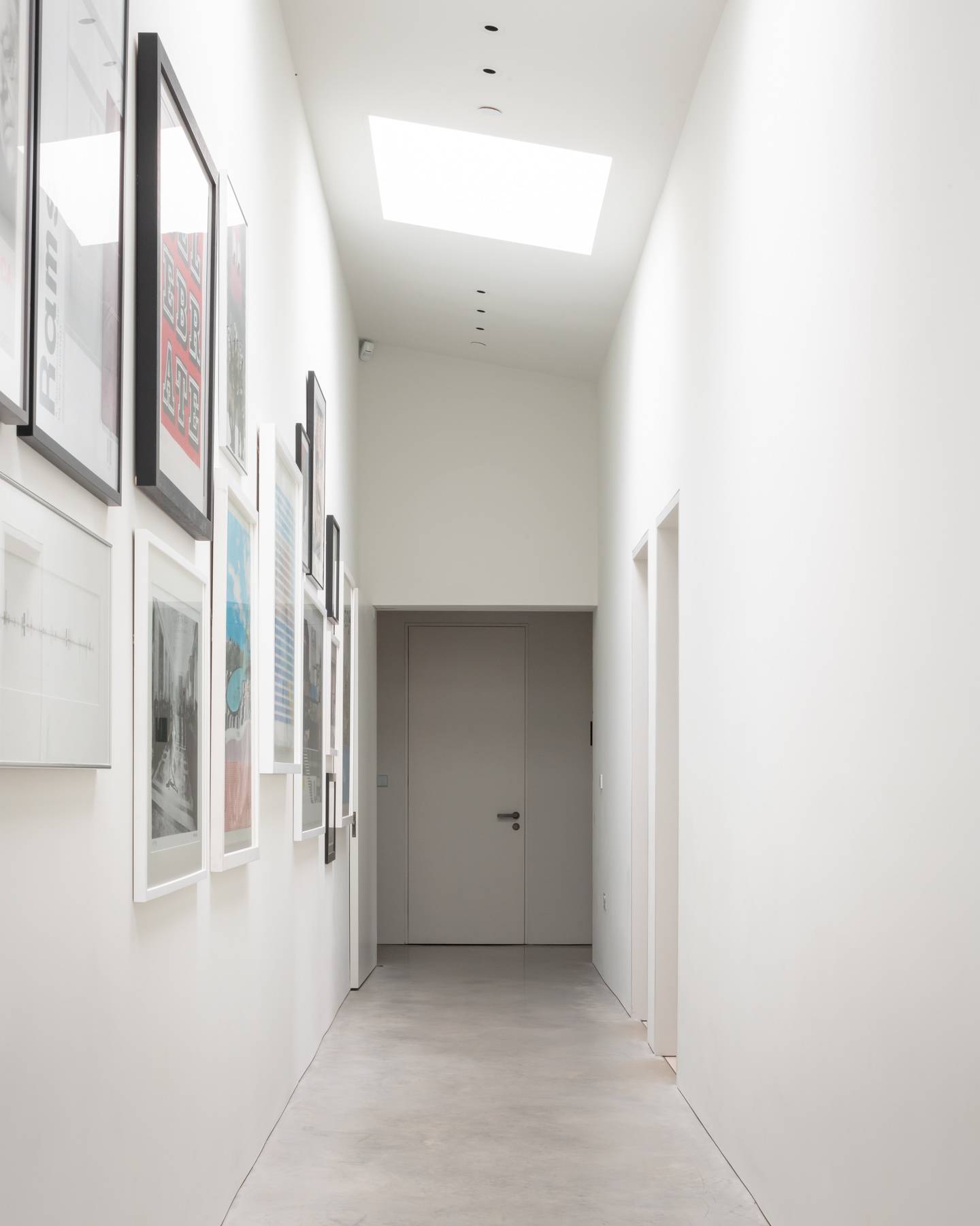 Bright white gallery hallway featuring framed artwork wall displays and polished concrete floors, Love Locations BN3.