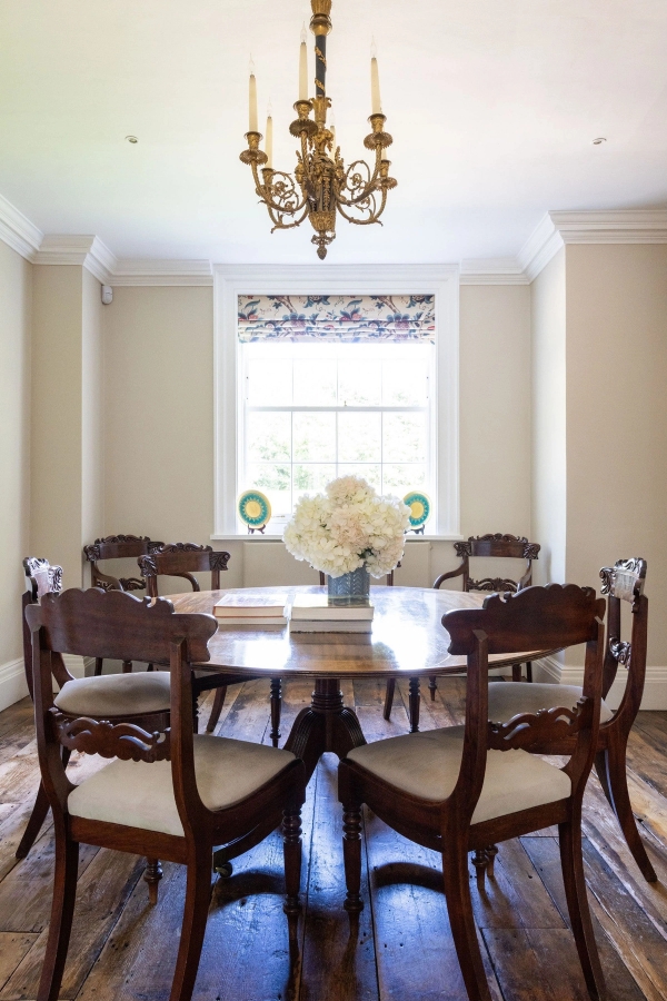 Love Locations traditional morning room Ashington BN44: Intimate circular mahogany dining suite beneath a crystal chandelier, perfect for period film sets and family brand commercials.