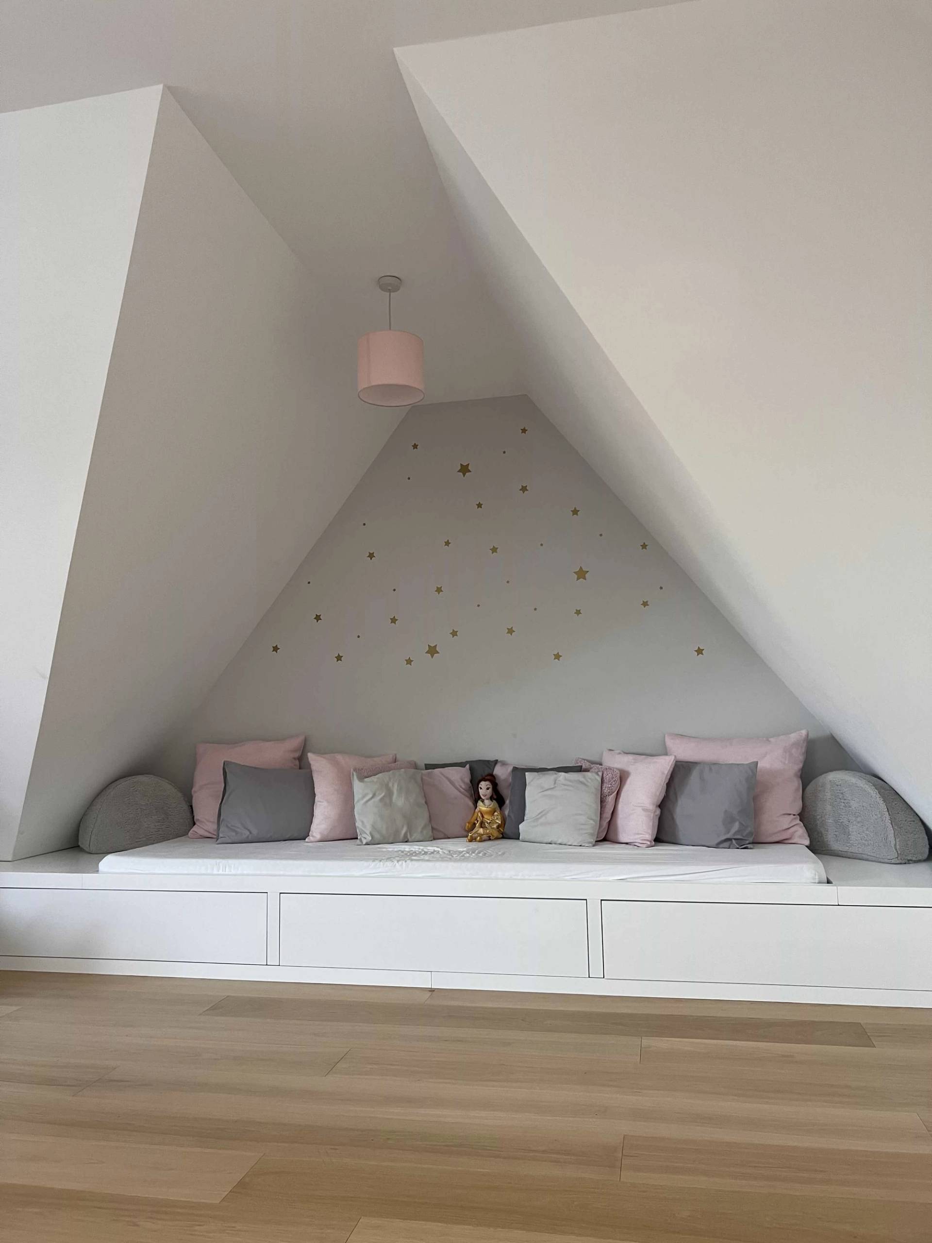 Cozy attic alcove daybed nook with plush pink cushions and starry wallpaper in a modern location home, perfect for children's apparel ads, Love Locations N3.