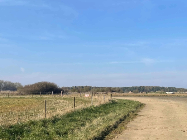 Quiet rural track running alongside open fields and farmland boundaries in Corby, NN17, ideal for vehicle tracking shots, Love Locations.