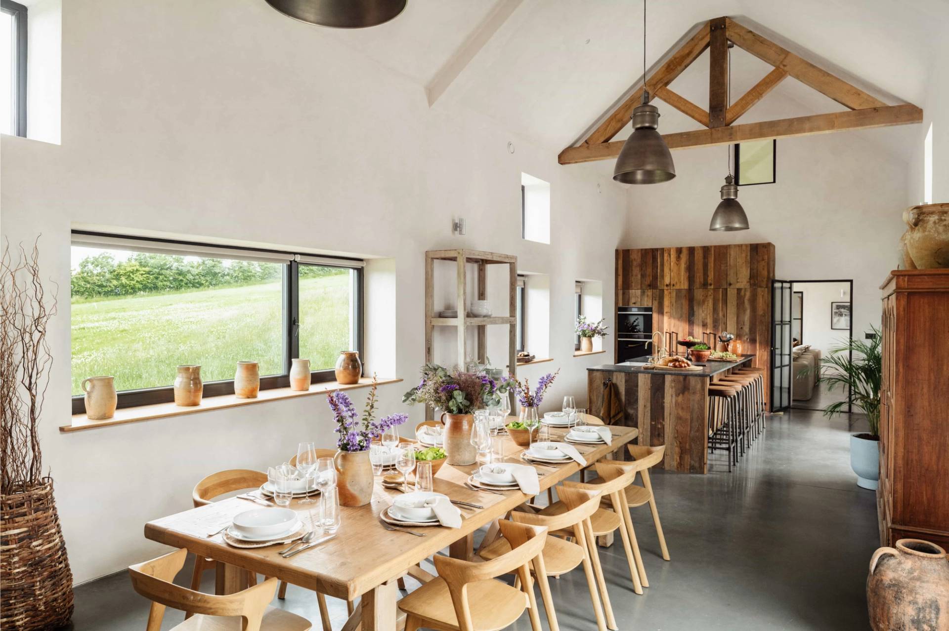 Sprawling dining hall photoshoot location in Castleblayney County Monaghan Ireland by Love Locations, featuring a long wooden banquet table, timber roof trusses, and scenic rural views.