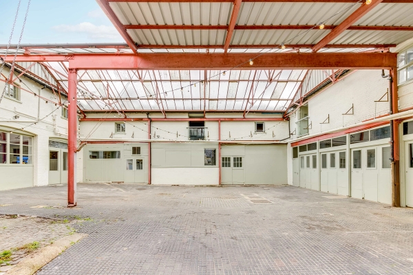 Large open-plan industrial warehouse yard with exposed steel frame for automotive and lifestyle shoots, listed by Love Locations.