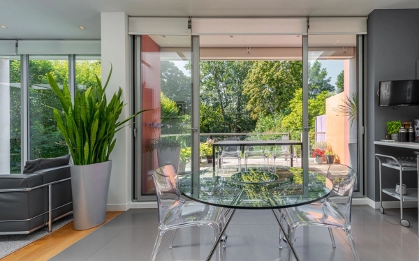 Bright, clean breakfast corner featuring minimalist furniture and large garden-facing windows, perfect for interior design catalog features, Love Locations W4.