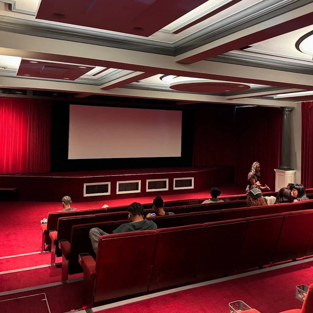 Broad view of a private screening room and cinema venue with plush crimson seating in Lewisham SE6 by Love Locations.