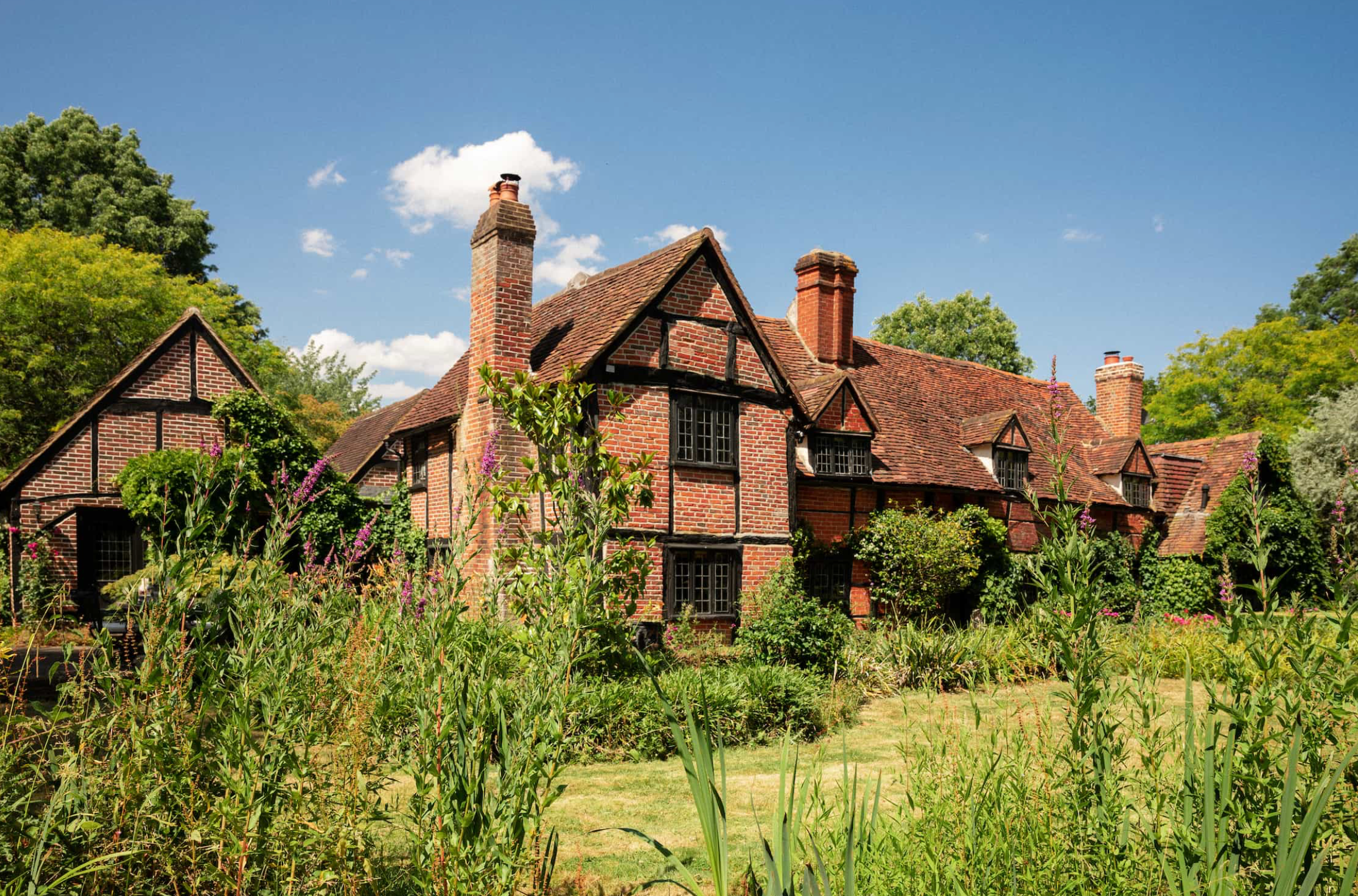 Characterful Tudor entrance with original timber framing, ivy-covered façade and heritage detailing, perfect for festive campaigns, film productions and lifestyle photography.