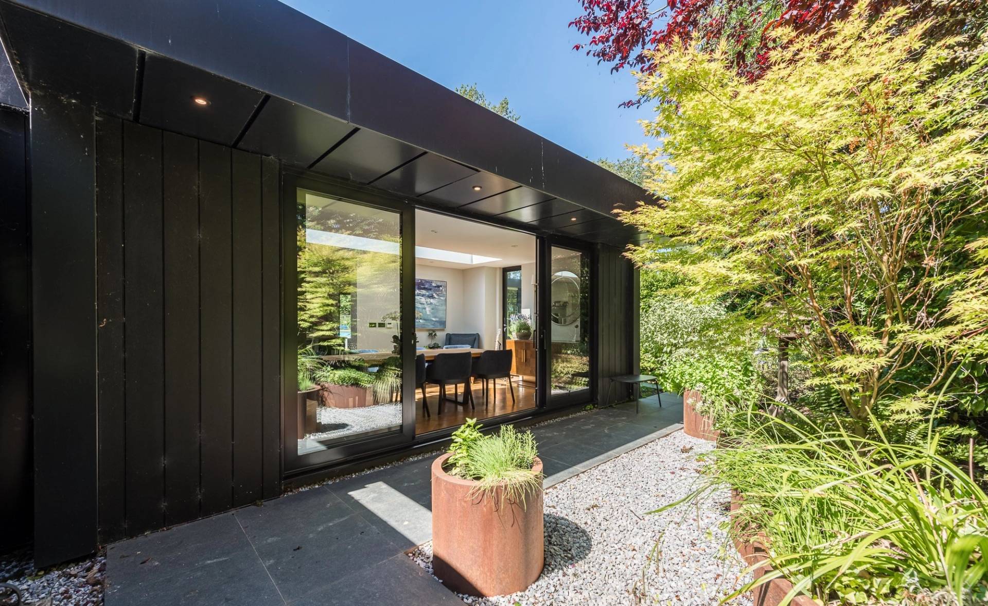 Detached modern garden office pod with floor-to-ceiling glass doors for corporate or commercial video shoots, Love Locations.