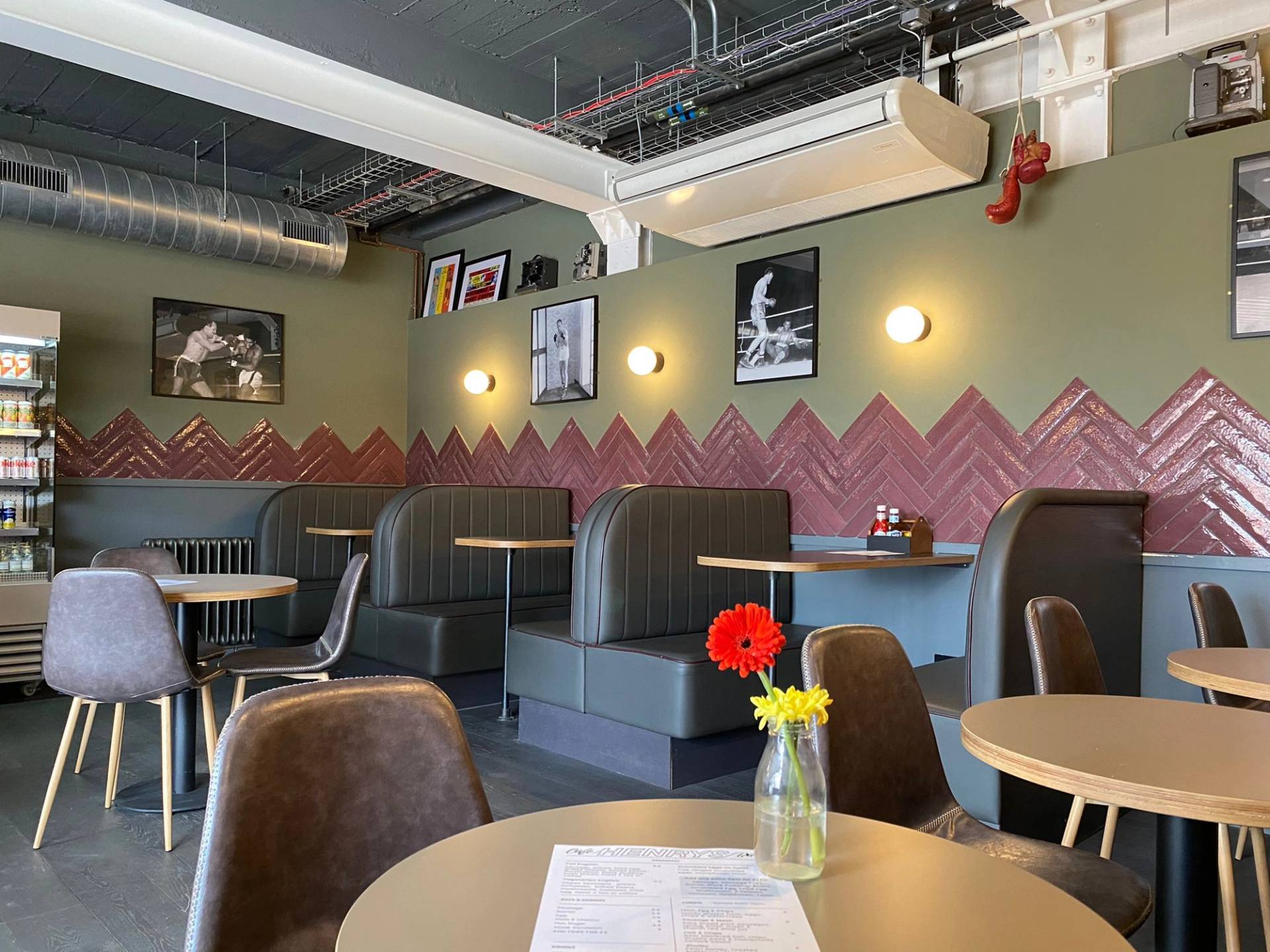 Retro pub dining booth seating area with modern artwork and warm lighting in Lewisham SE6 from Love Locations.