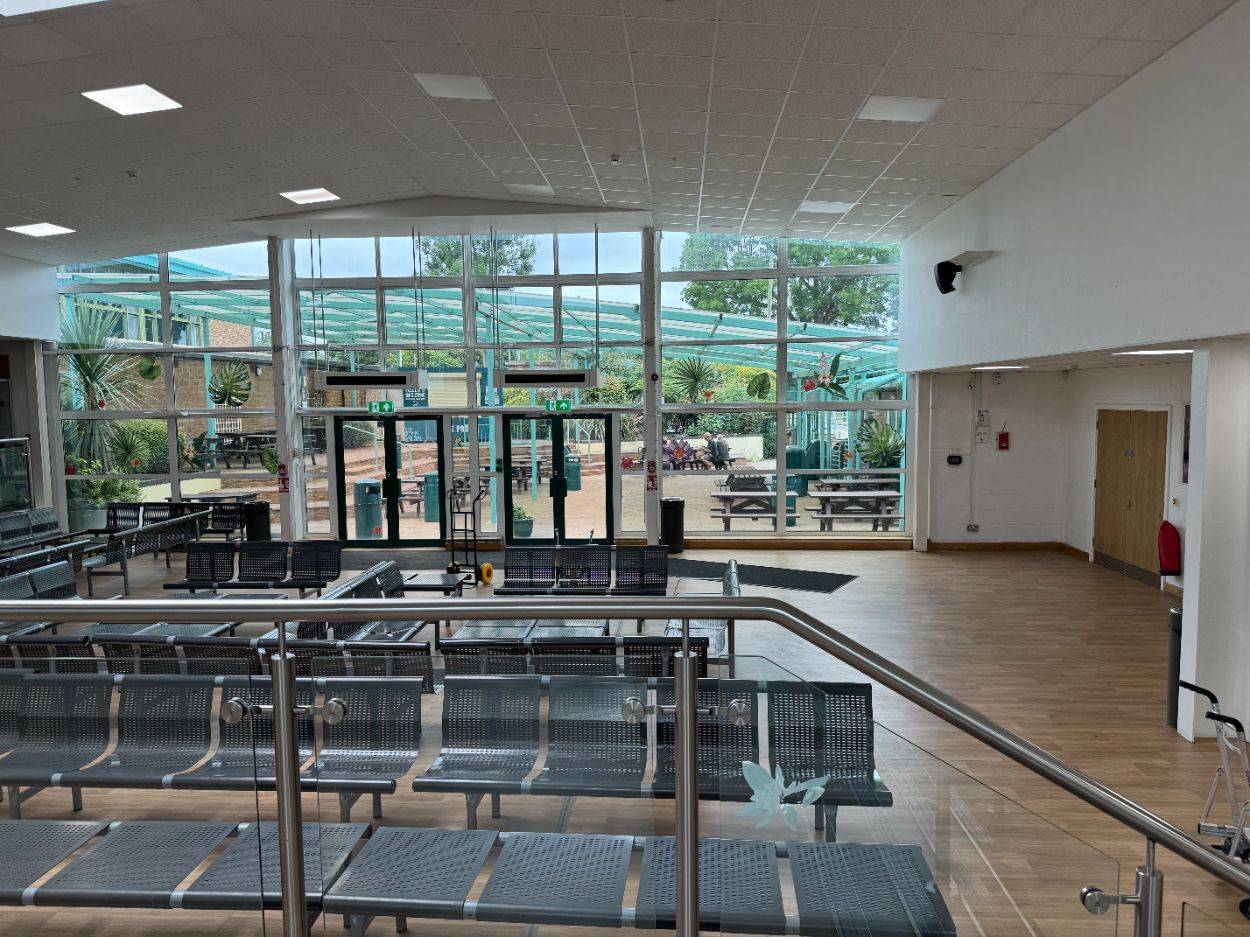 Modern school atrium and cafeteria dining hall shoot space with metal seating and glass entrance doors through Love Locations.