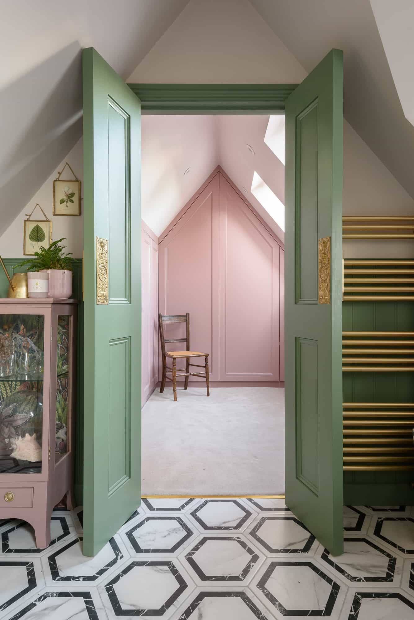 Sage green double doors opening into a pink dressing room suite set under sloped attic ceilings, Love Locations TW11.