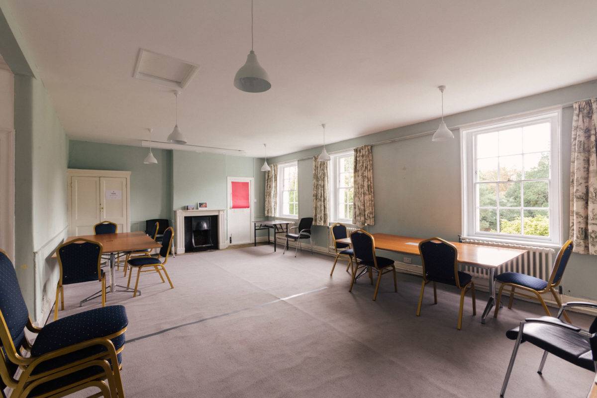Spacious production room or meeting space with soft mint green walls and dual light fixtures, Love Locations SE15.