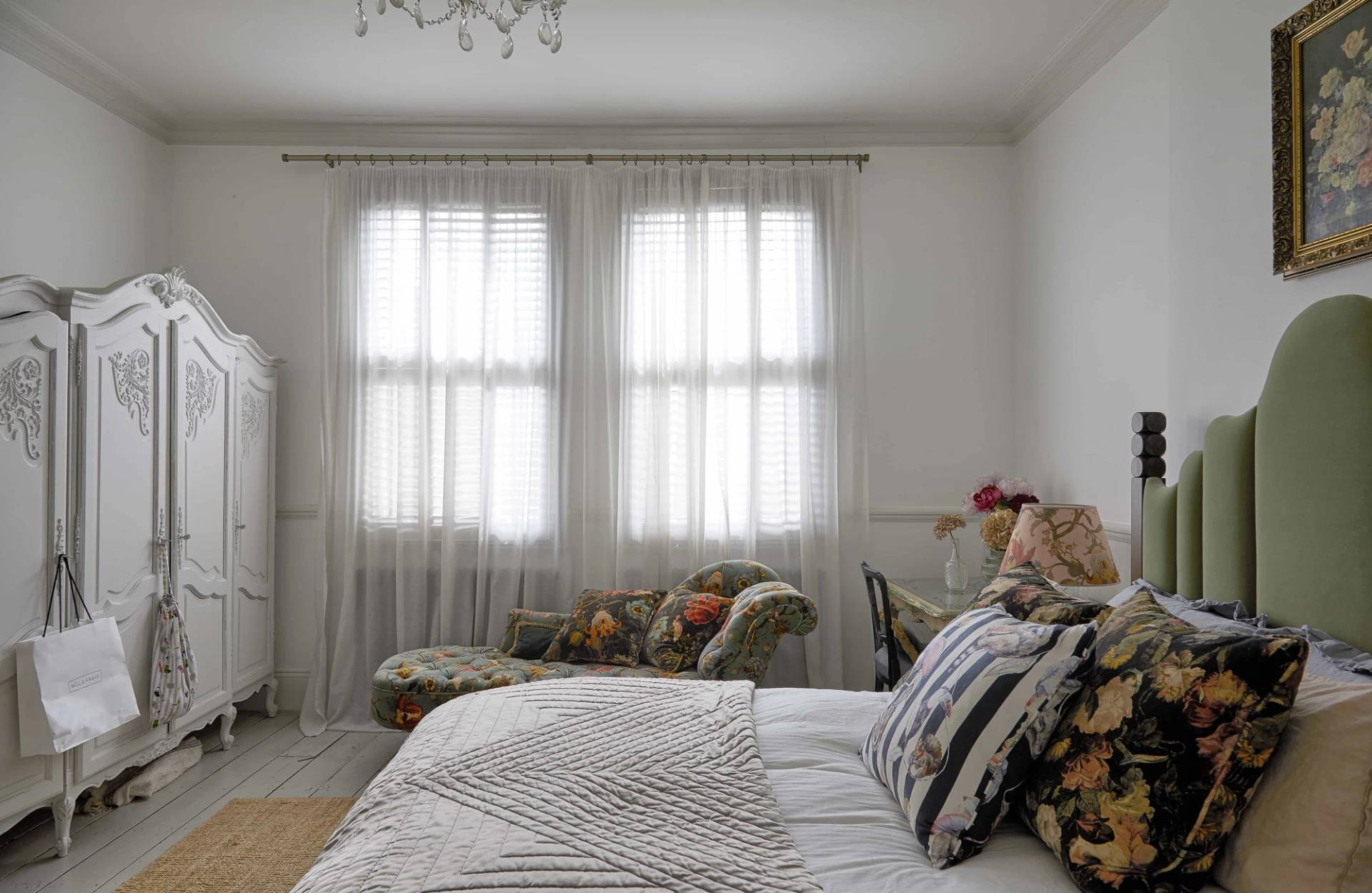 Serene bedroom setup with sheer window drapes, low platform bed, and neutral linens, Love Locations Finsbury Park.