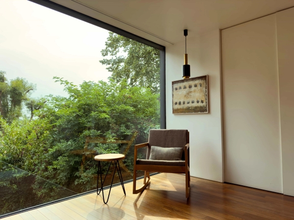 Bedroom with balcony view at Highgate Zen Love Locations property overlooking the garden.