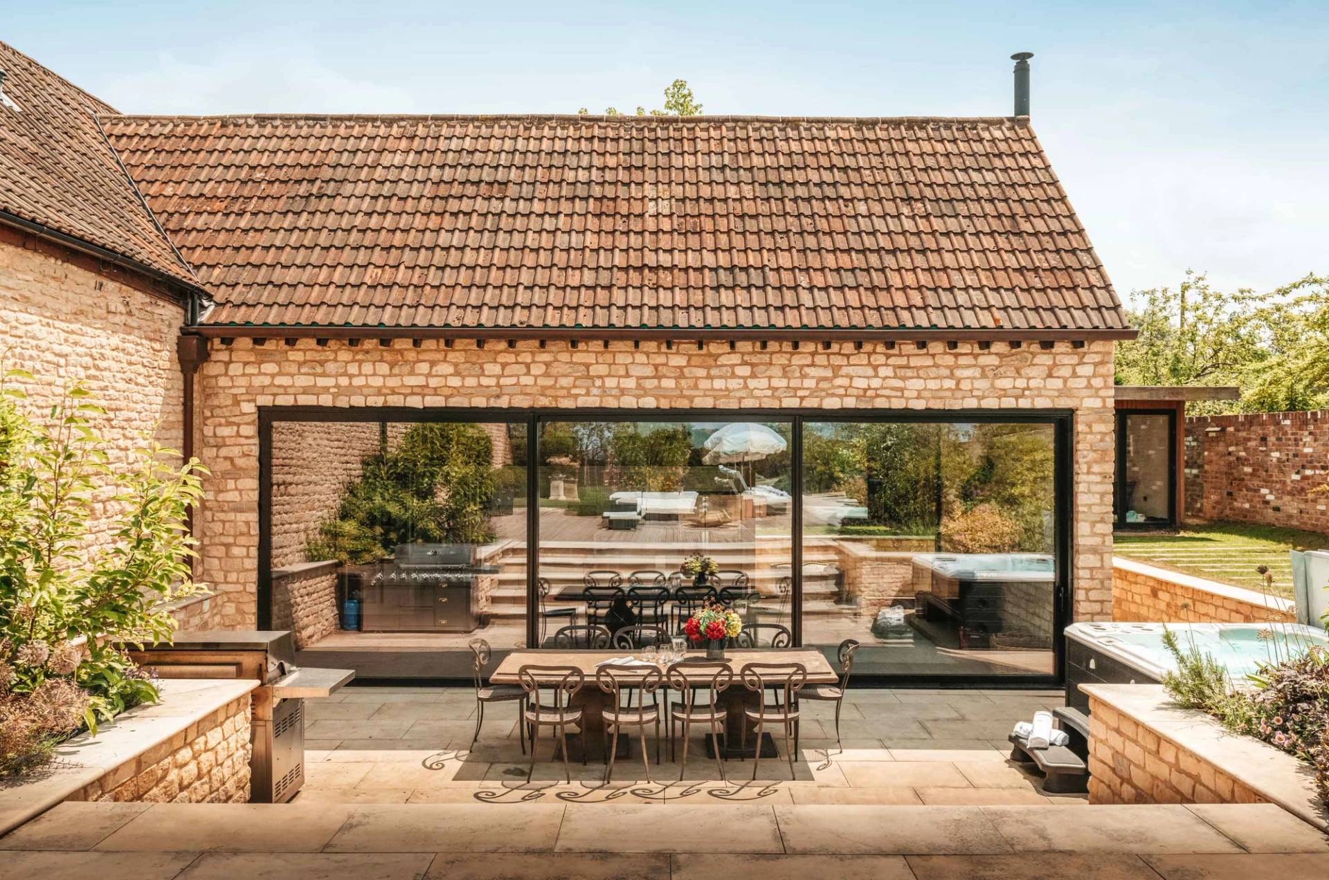 Mediterranean-style tiled roof exterior and outdoor dining terrace shoot location in Cheltenham GL51 via Love Locations.