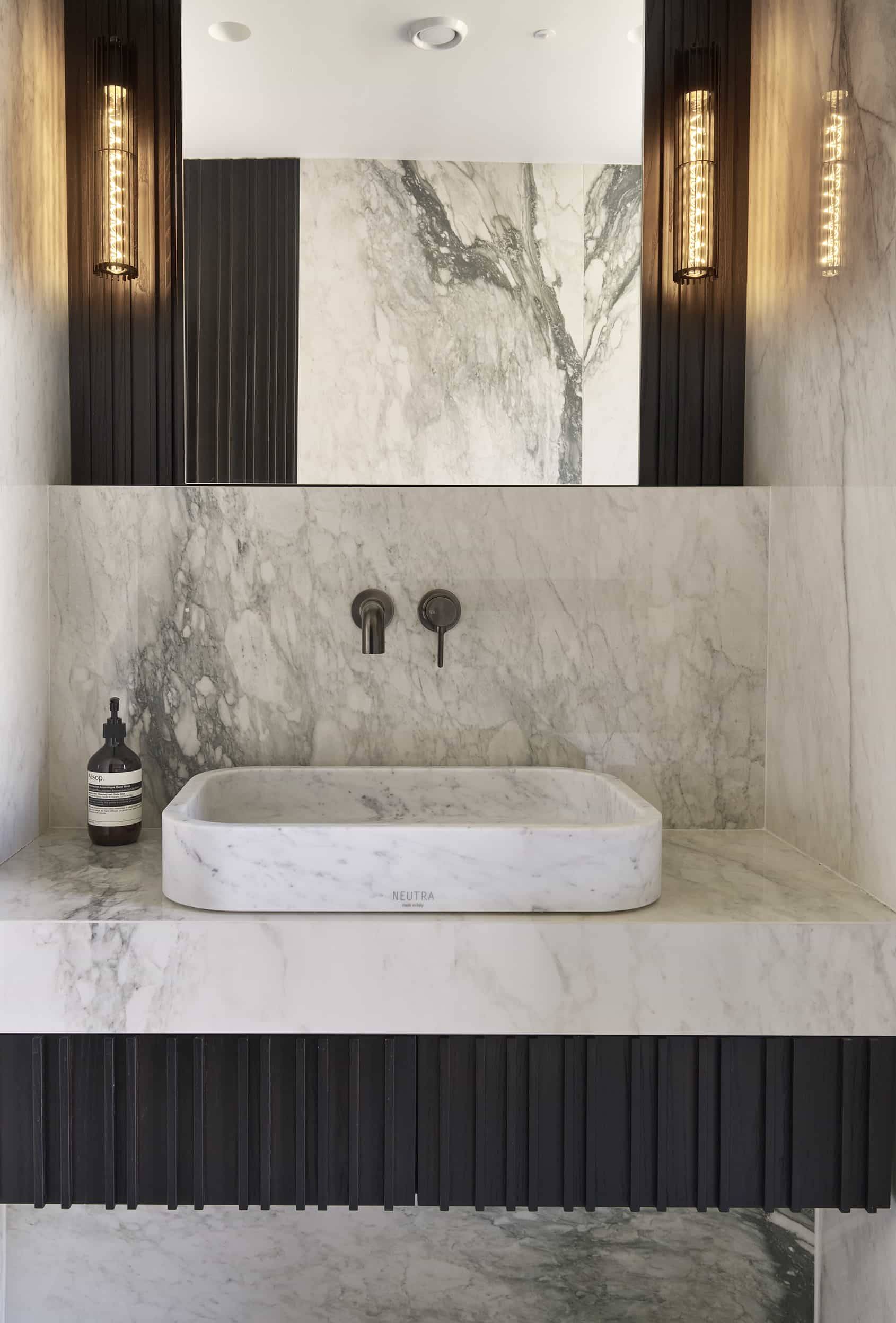 Bespoke solid marble washbasin and contemporary bathroom design for high-end brand campaigns, listed on Love Locations.