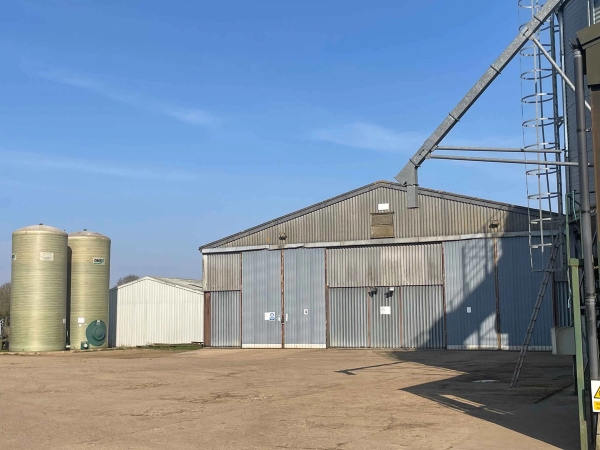 Large industrial agricultural barn with sliding doors and grain processing towers, suitable for large-scale set builds, Love Locations.