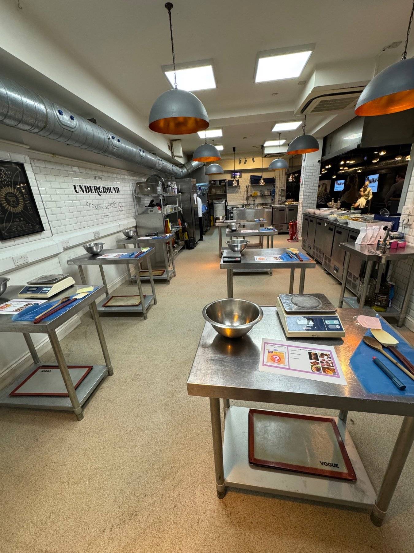 Expansive underground commercial kitchen for hire, showing the full length of the preparation floor in Central London, via Love Locations.