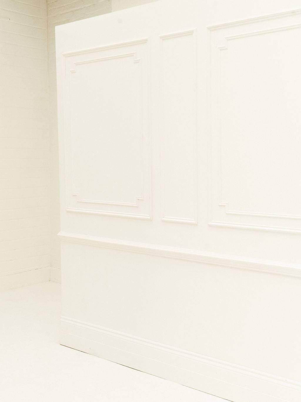 Stylish white panelled wall event backdrop at Brixton Warehouse Love Locations, perfect for weddings and corporate gatherings.