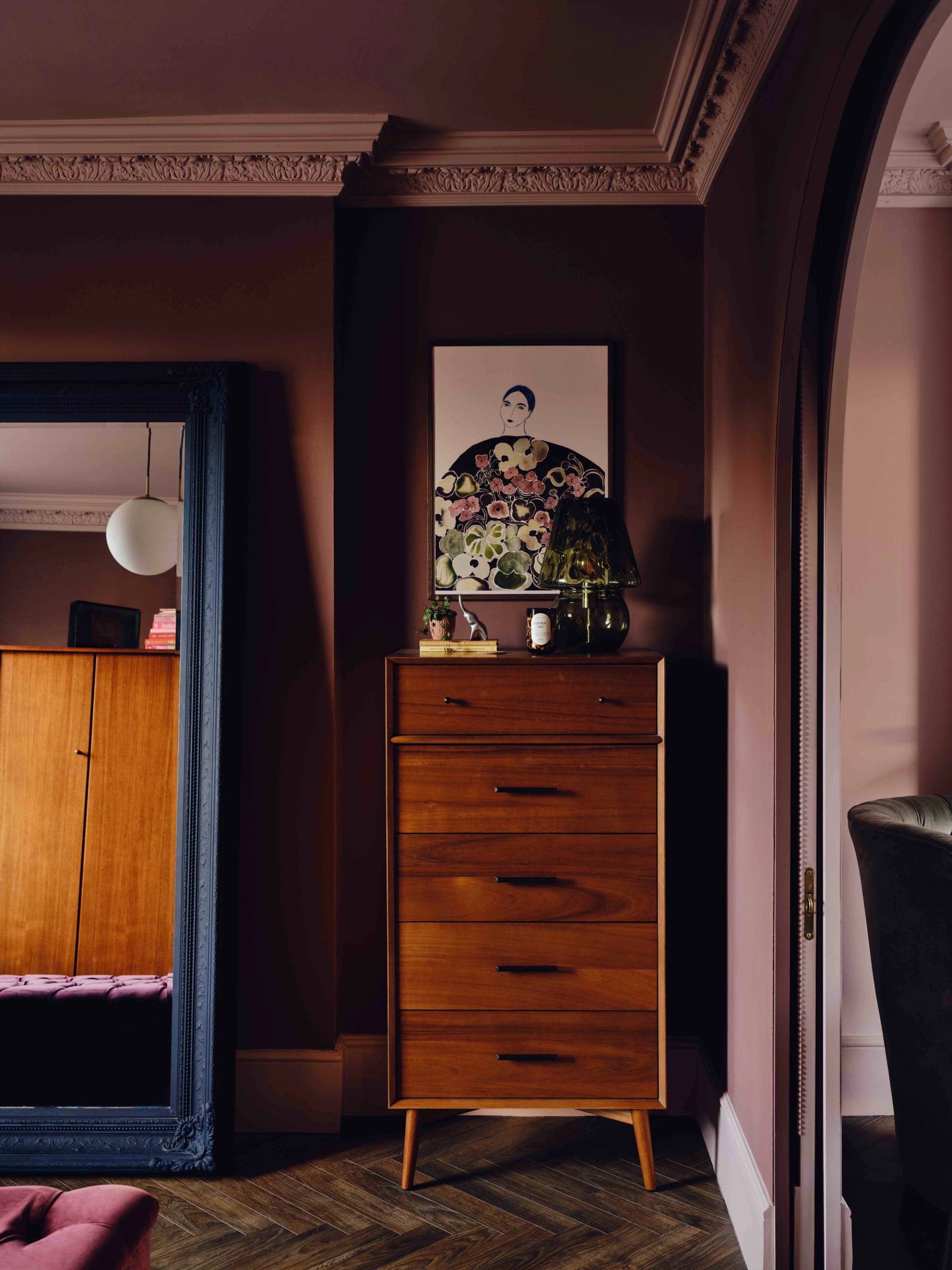 Vintage wooden chest of drawers set against plaster pink walls with a tall floor mirror, Love Locations CR0.