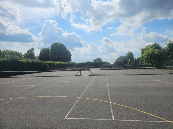 Outdoor tarmac school playground and sports tennis courts for commercial film productions under a blue sky, Love Locations.