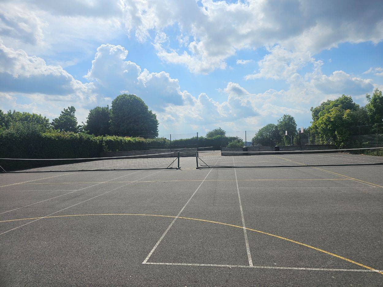 Outdoor tarmac school playground and sports tennis courts for commercial film productions under a blue sky, Love Locations.