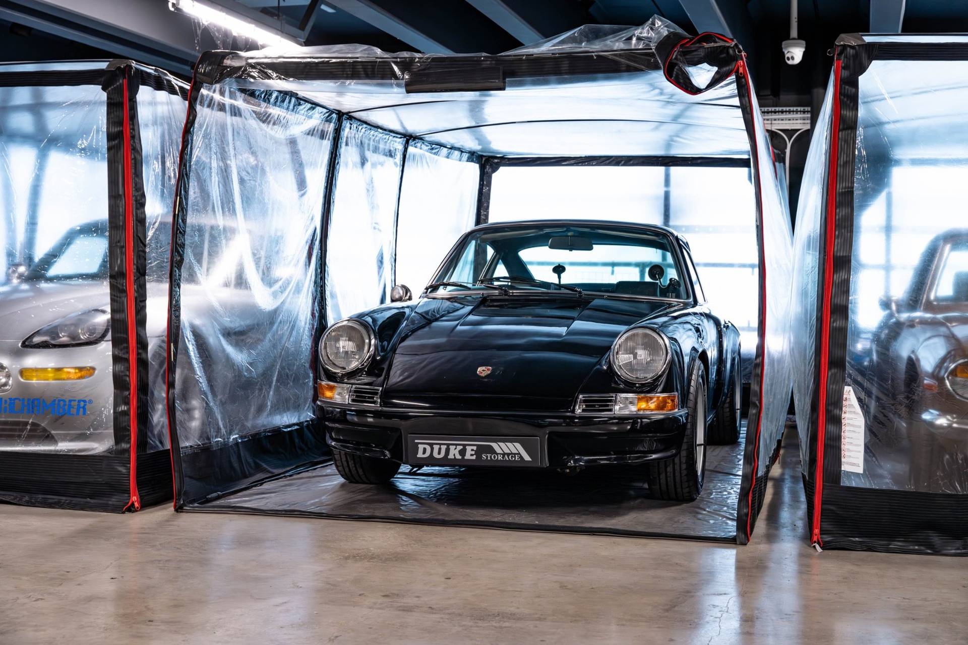 Classic black Porsche 911 in a clear protective storage capsule in Brentford TW8 via Love Locations.