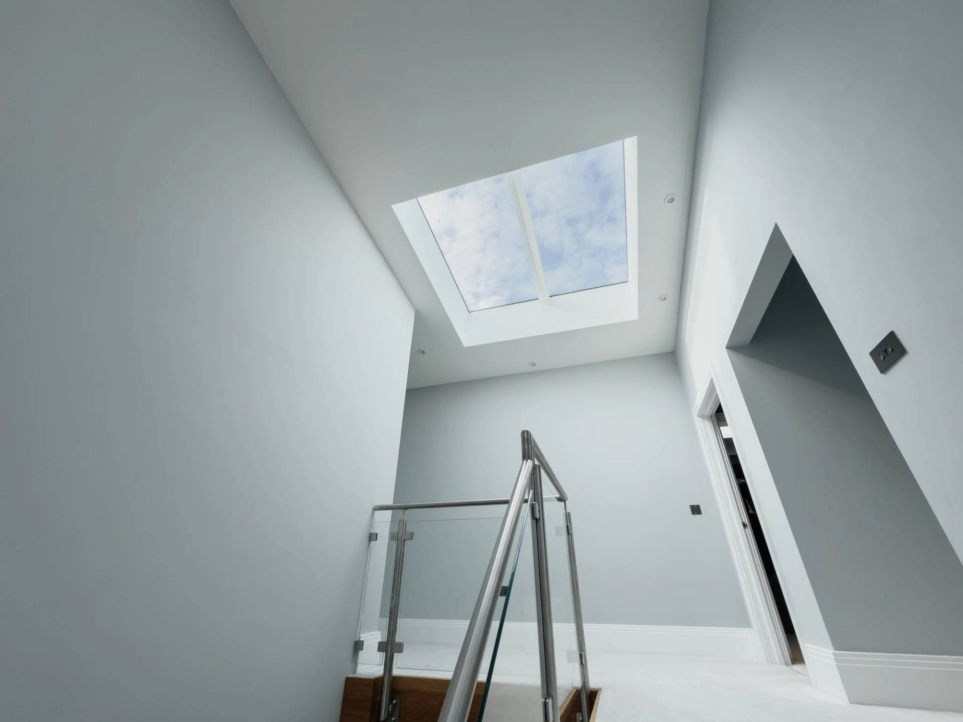 Architectural glass balustrade stairwell and skylight feature inside a luxury modern home in Barnet EN4 by Love Locations.