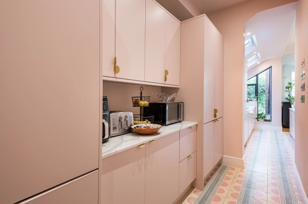 Bespoke floor-to-ceiling pink kitchen pantry cupboard storage units for lifestyle brand filming, Love Locations North London.