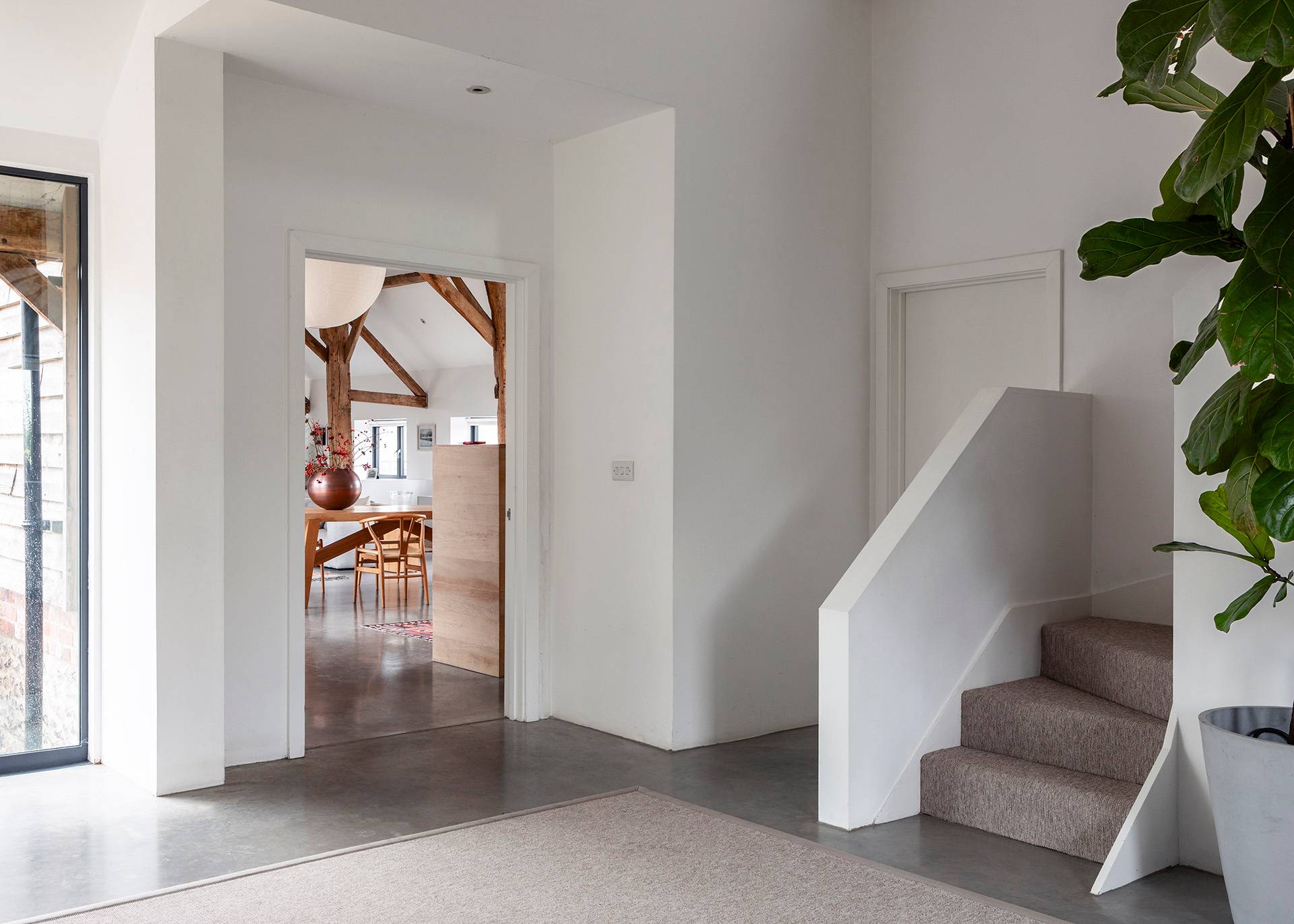 Minimalist white staircase and inner hallway corridor leading into a contemporary extension, Love Locations SN8.