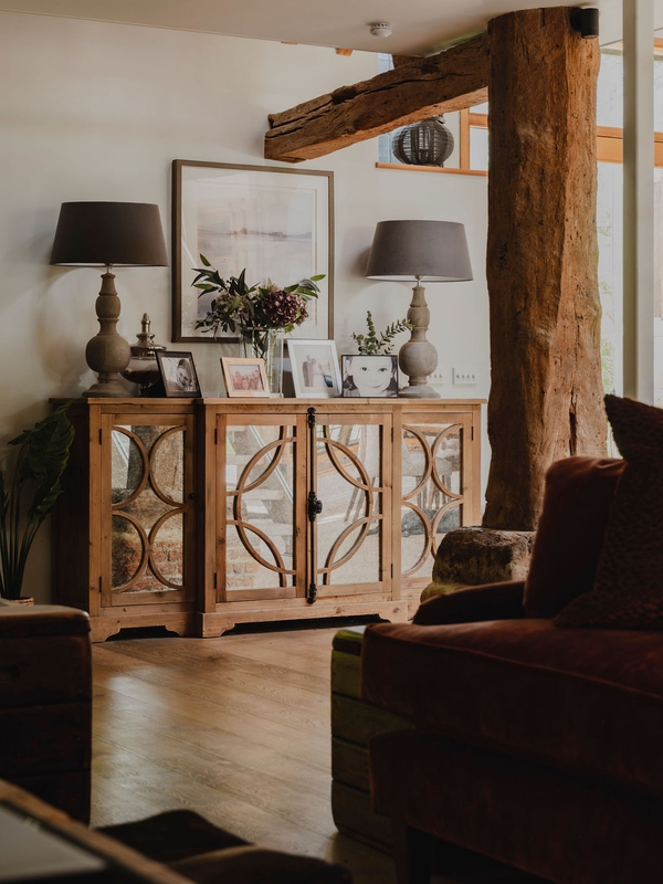 Mirrored side console table with matching table lamps set against exposed oak timber pillars, ideal for luxury furniture lookbooks, Love Locations RG9.