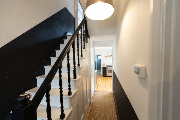 Love Locations monochrome hallway location E7: Striking staircase view with dark painted banisters, crisp white steps, and a minimalist color-blocked wall accent, optimized for artistic cinematic scenes.