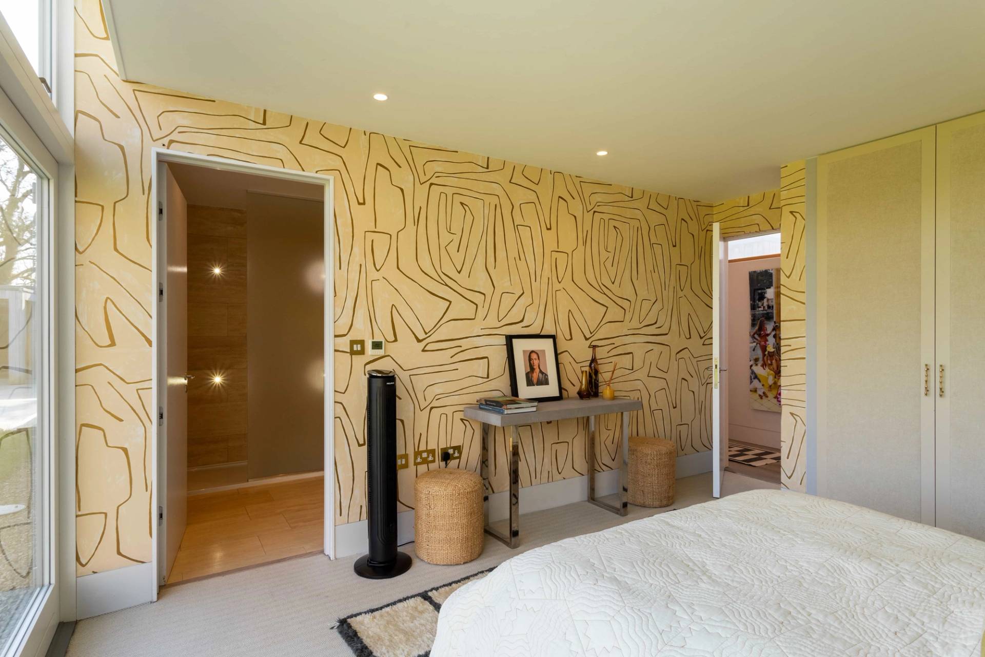 Love Locations unique bedroom backdrop Godalming: Wide angle viewpoint of a graphic print bedroom transitioning into an open vanity closet, optimized for fashion lookbook videos.
