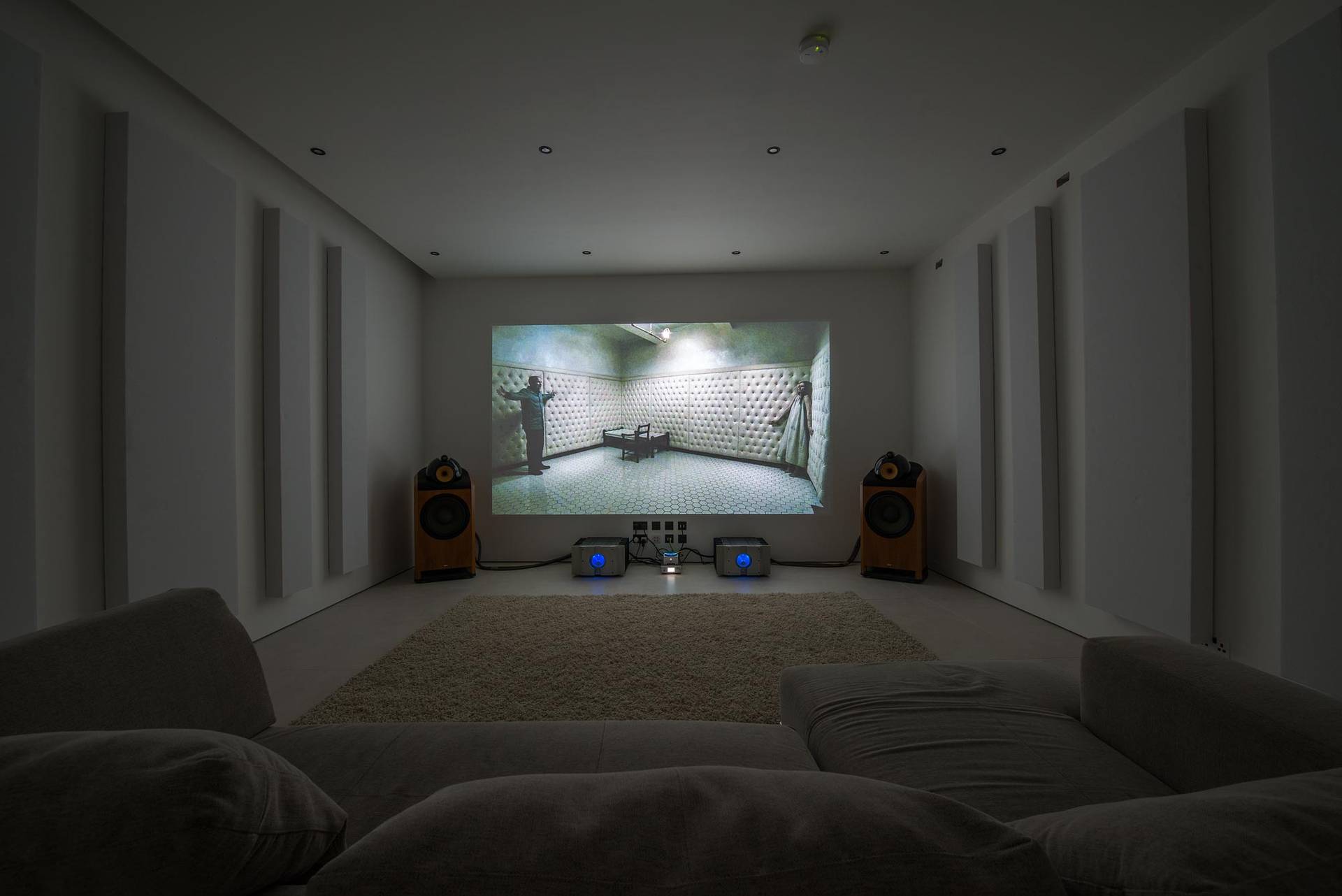 Private home cinema room with a large projection screen, ambient wall lighting, and plush seating, Love Locations SW6.