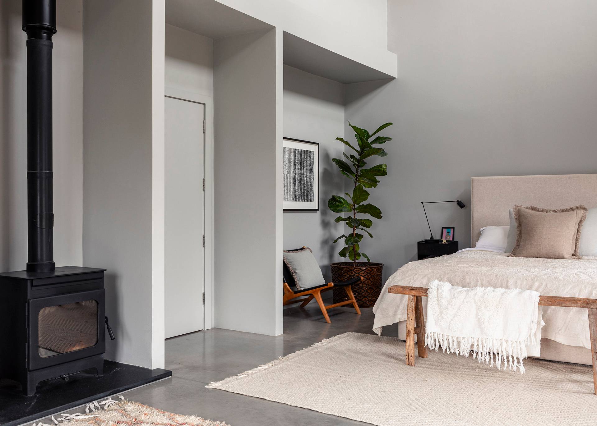 Master bedroom suite looking toward a private ensuite doorway and potted tropical plant, Love Locations SN8.