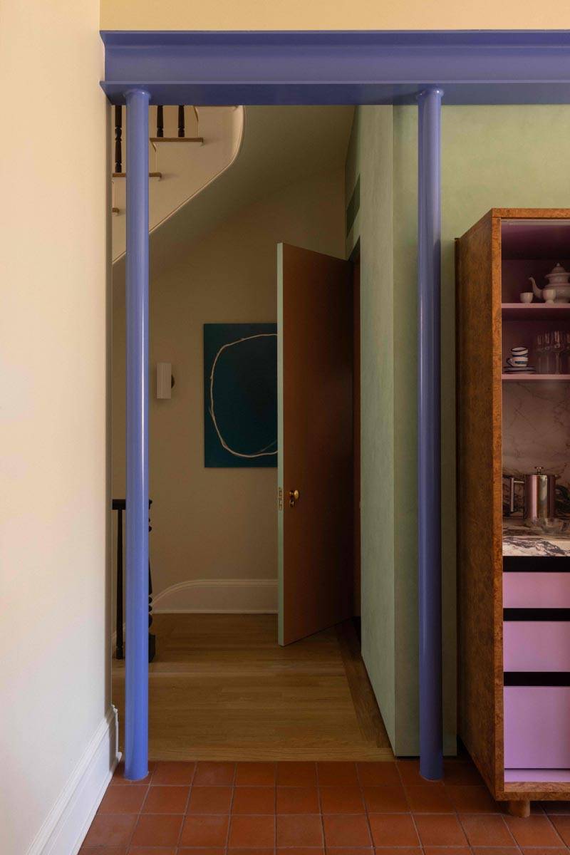 Minimalist hallway shoot location in a 19th-century Brooklyn townhouse featuring lavender door trim and light wood flooring, available via Love Locations.